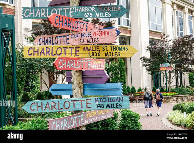 charlotte-north-carolinasouth-tryon-streetother-cities-named-charlotte-multi-directional-signspedestrianswalking-street-scene-2RGEGTK
